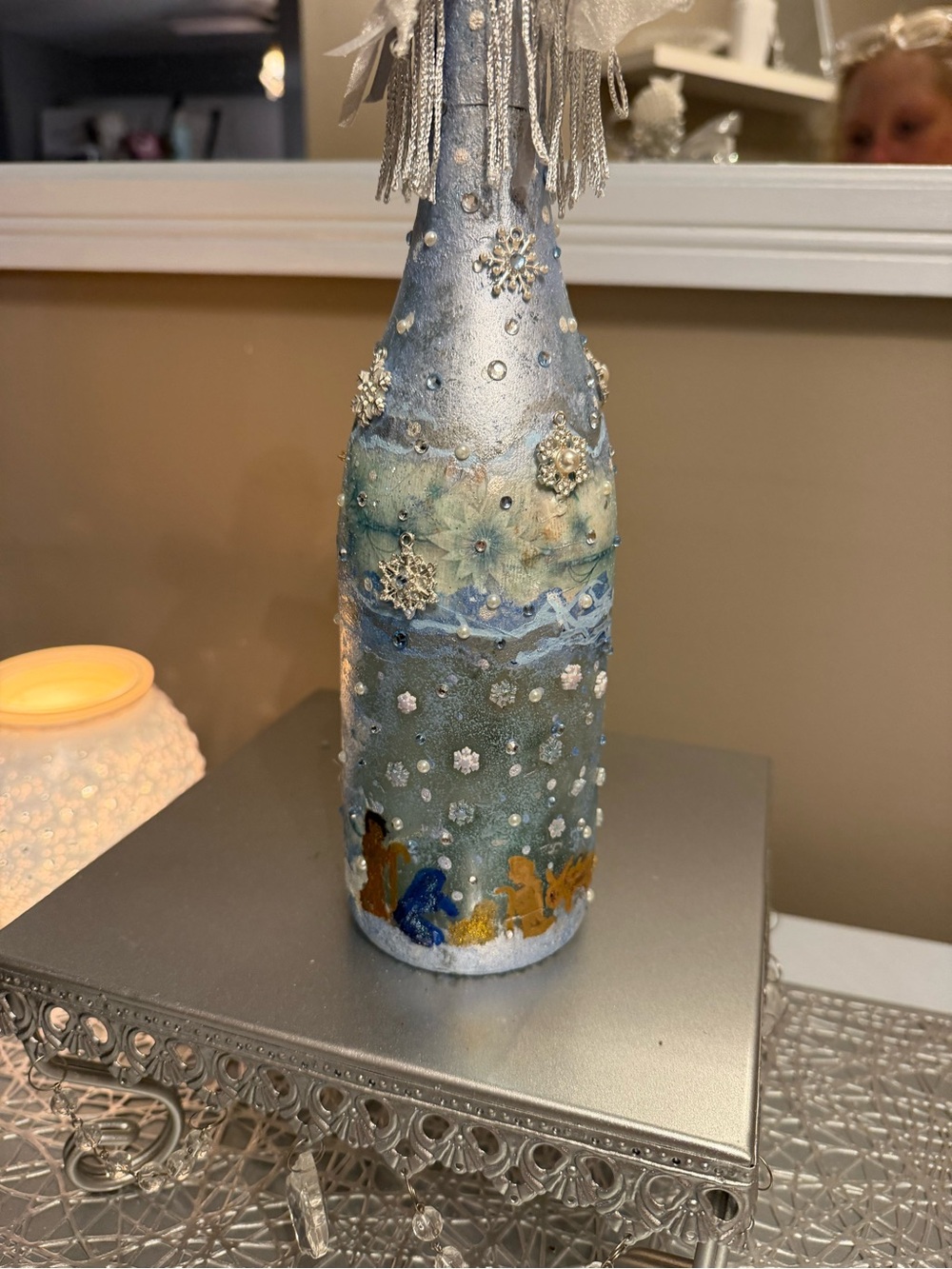 Christmas bottle with winter nativity scene and fairy lights